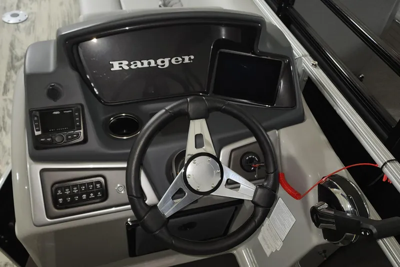 Slide: The Image of 2024 Ranger Reata 220C boat dashboard with steering wheel and control panel. - 10