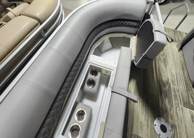 Slide: The Image of 2024 Ranger Reata 220C boat interior with gray cushioned seating and cup holders. - 4