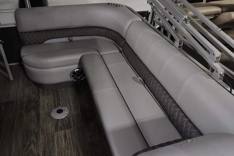 Slide: The Image of 2024 Ranger Reata 220C boat interior with gray cushioned seating and wood flooring. - 9