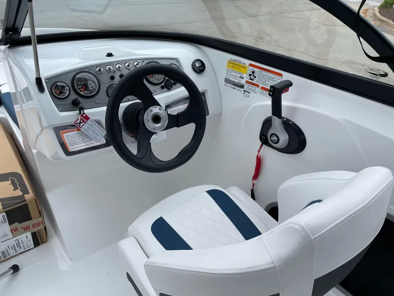 Slide: The Image of 2024 Tahoe 185 S boat cockpit with steering wheel and control panel. - 5