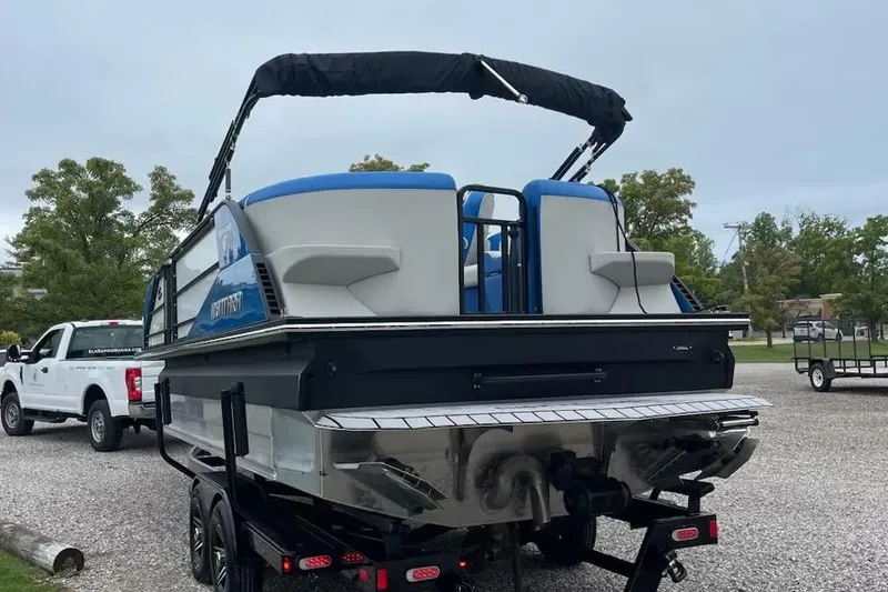 Slide: The Image of 2021 Montara 23' Surfboss boat on trailer, parked outdoors. - 3