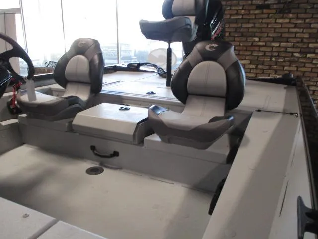 Slide: The Image of 2024 Crestliner CXFC18 boat interior with dual seats and steering wheel. - 4