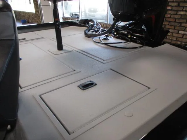 Slide: The Image of 2024 Crestliner CXFC18 boat deck with storage compartments and motor. - 5