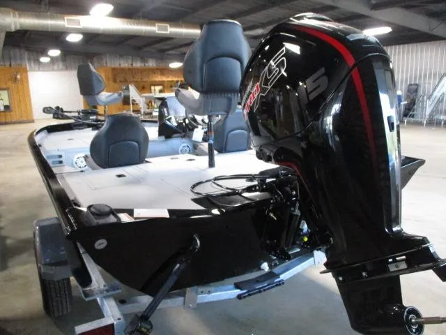 Slide: The Image of 2024 Crestliner CXFC18 boat with powerful outboard motor in a showroom. - 7