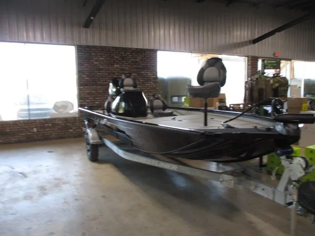 Slide: The Image of 2024 Crestliner CXFC18 fishing boat displayed indoors on a trailer. - 8