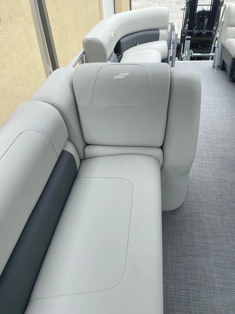 Slide: The Image of 2024 Starcraft LX 20 R boat interior with gray seating and carpeted flooring. - 10