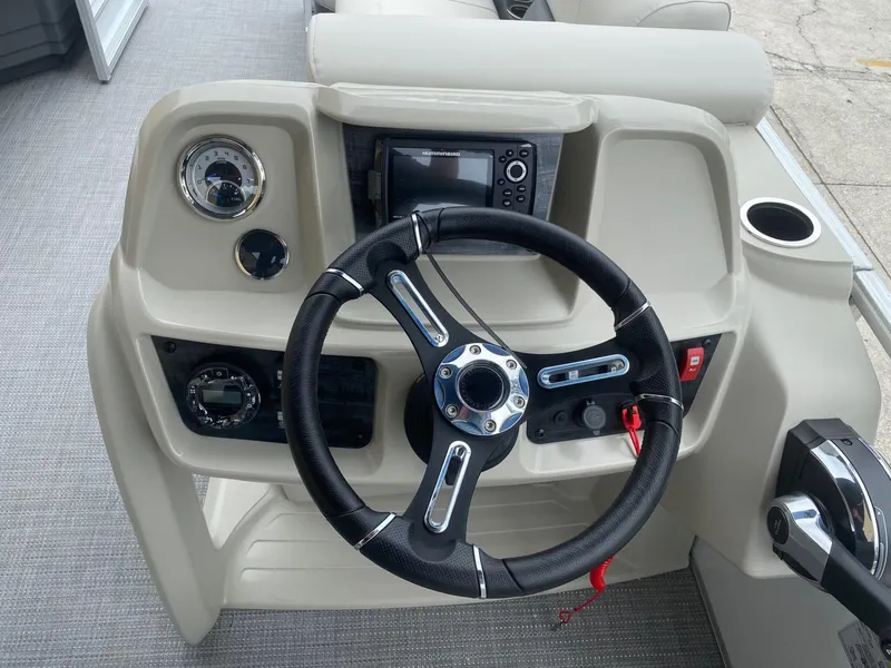 Slide: The Image of 2024 Starcraft LX 20 R boat dashboard with steering wheel and control panel. - 11