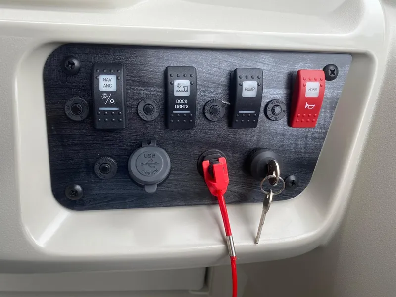 Slide: The Image of Control panel of 2024 Starcraft LX 20 R boat with switches and USB port. - 12