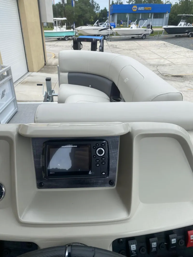 Slide: The Image of 2024 Starcraft LX 20 R boat interior with control panel and seating. - 15