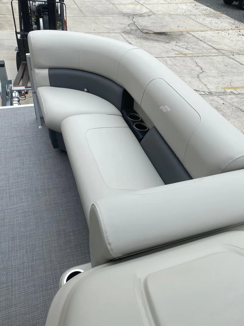 Slide: The Image of 2024 Starcraft LX 20 R boat interior with plush seating and cup holders. - 17