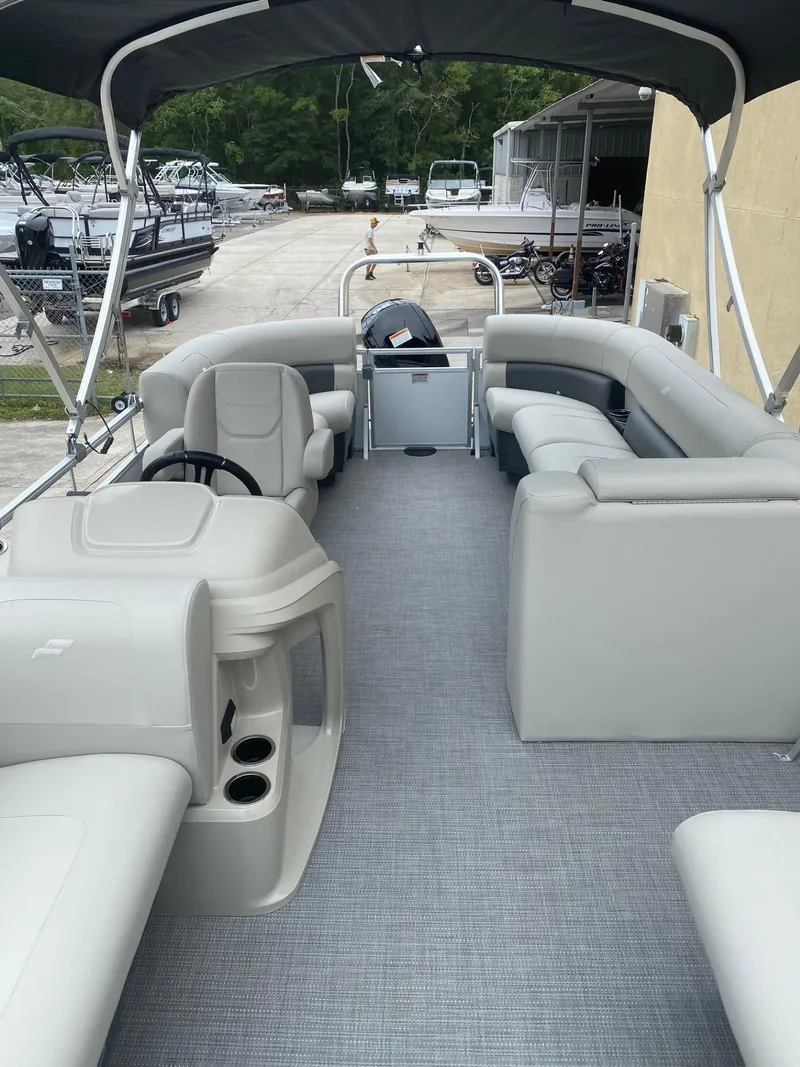 Slide: The Image of 2024 Starcraft LX 20 R pontoon boat with spacious seating and modern design. - 19