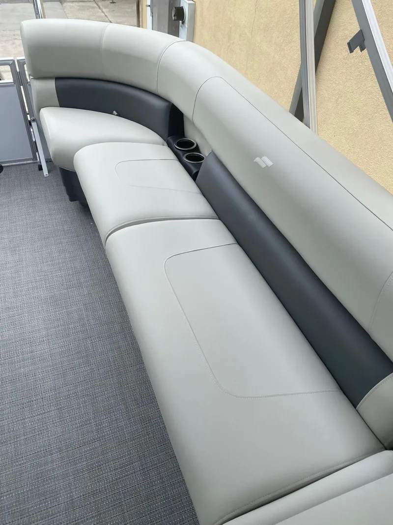 Slide: The Image of 2024 Starcraft LX 20 R boat interior with gray seating and cup holders. - 6