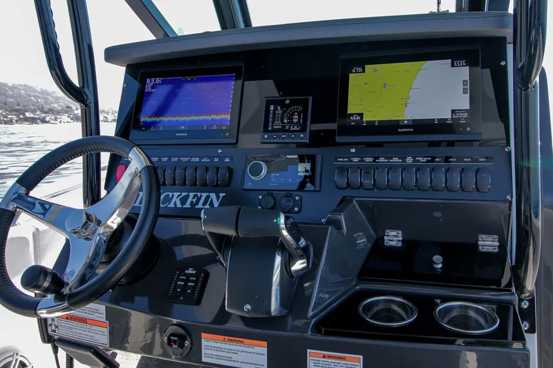 Slide: The Image of 2023 Blackfin 272 CC boat dashboard with navigation screens and controls. - 13
