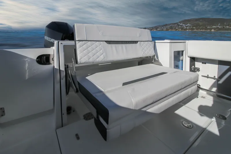 Slide: The Image of 2023 Blackfin 272 CC boat with cushioned seating and scenic ocean view. - 16