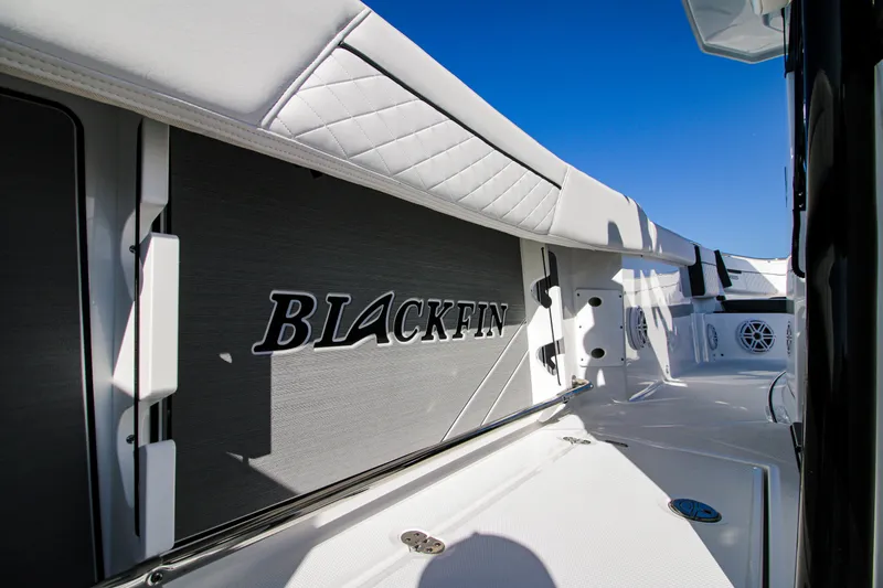 Slide: The Image of 2023 Blackfin 272 CC boat interior with logo, featuring sleek white and black design. - 20