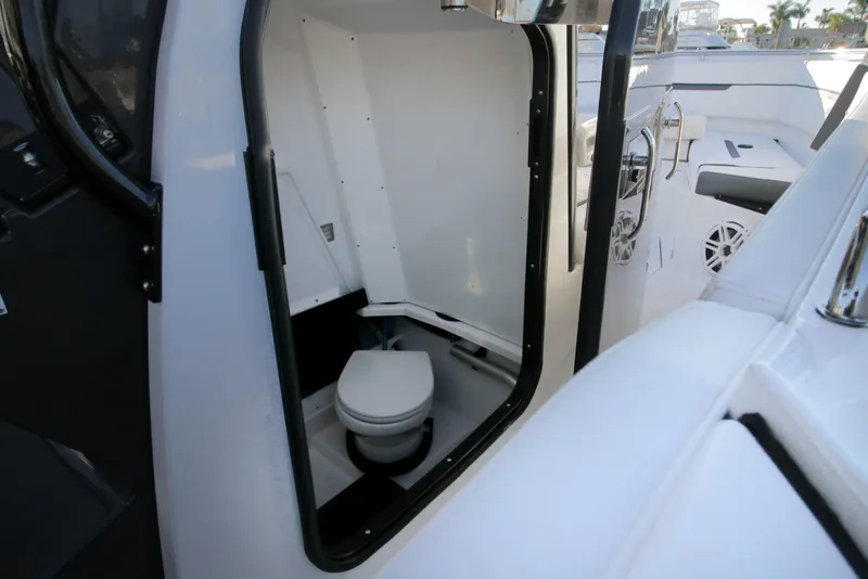 Slide: The Image of 2023 Blackfin 272 CC boat interior with compact marine toilet. - 23