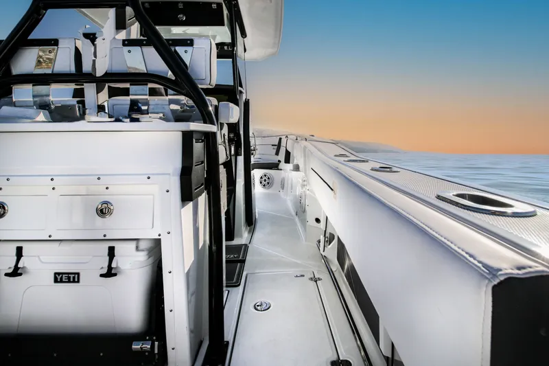Slide: The Image of 2023 Blackfin 272 CC boat interior with sleek design at sunset on the water. - 8
