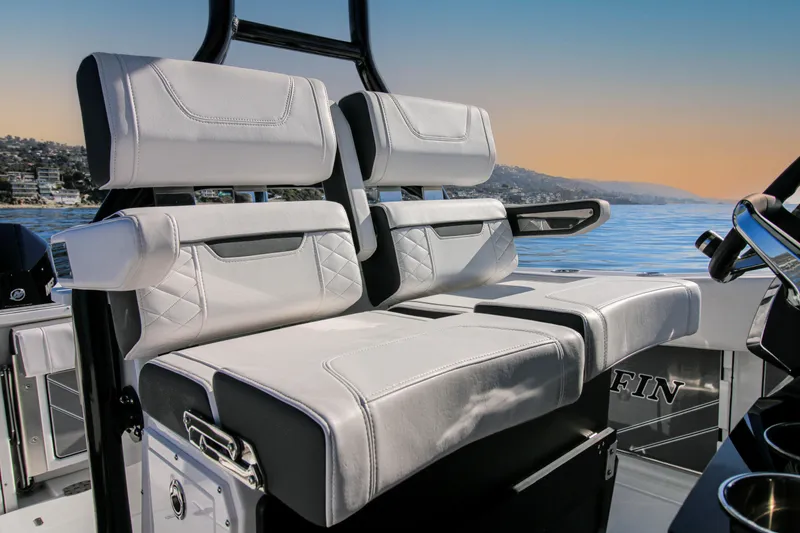 Slide: The Image of 2023 Blackfin 272 CC boat interior with luxurious seating, ocean view in background. - 9
