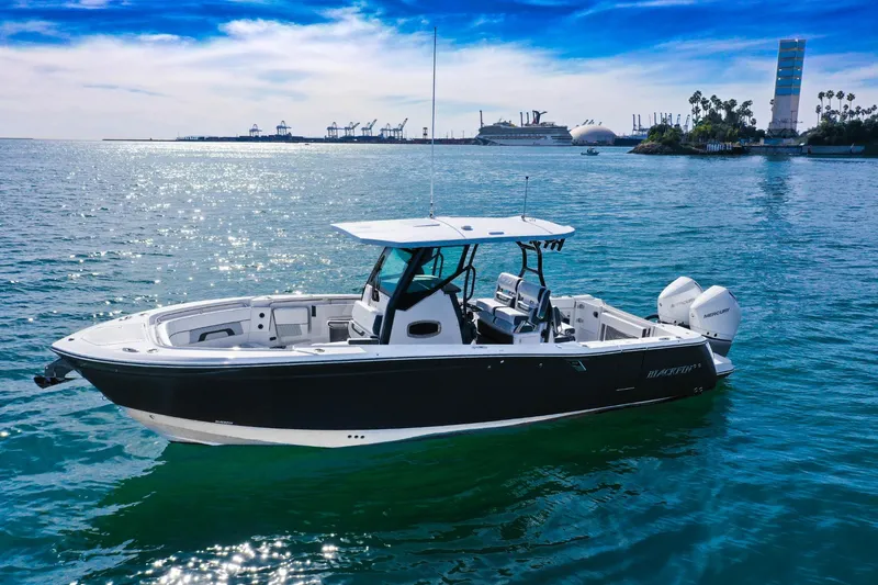The Image of 2023 Blackfin 302 CC boat on calm ocean near harbor. - 0