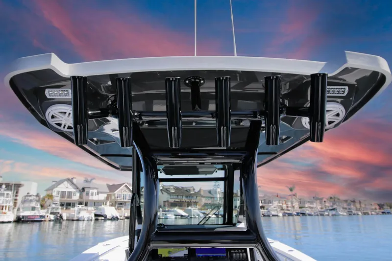 Slide: The Image of 2023 Blackfin 302 CC boat with sleek design against a vibrant sunset sky. - 14