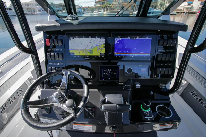 Slide: The Image of 2023 Blackfin 302 CC boat dashboard with navigation screens and controls. - 16
