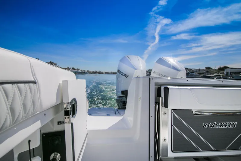 Slide: The Image of 2023 Blackfin 302 CC boat with dual Mercury engines on a sunny day. - 21