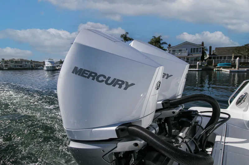 Slide: The Image of 2023 Blackfin 302 CC boat with Mercury engines cruising on a scenic waterway. - 22