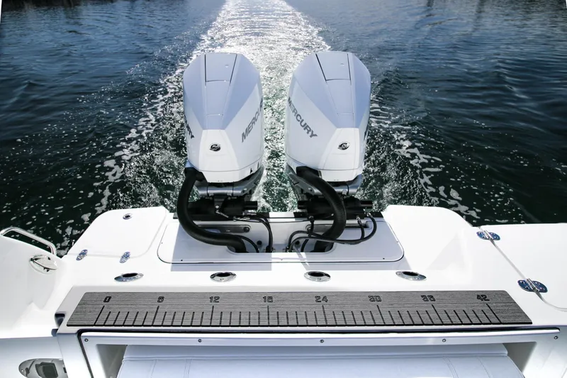 Slide: The Image of 2023 Blackfin 302 CC boat with dual Mercury outboard engines on water. - 24