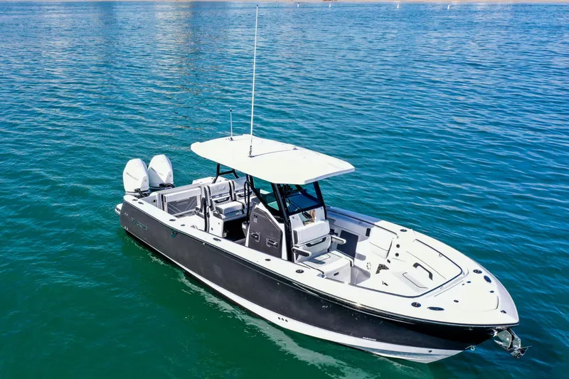 Slide: The Image of 2023 Blackfin 302 CC boat on clear blue water, featuring sleek design and twin engines. - 5