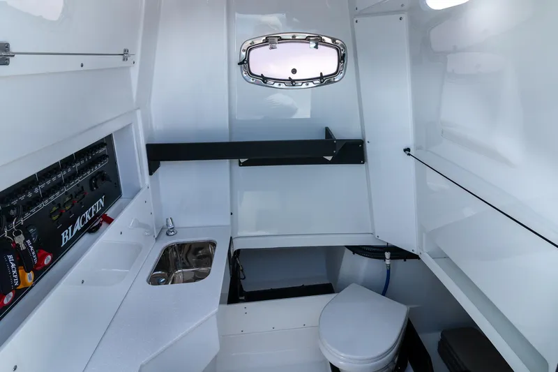 Slide: The Image of 2024 Blackfin 332 CC cabin interior with sink, toilet, and storage compartments. - 13