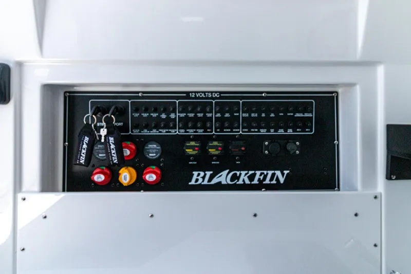 Slide: The Image of Control panel of 2024 Blackfin 332 CC boat with switches and key fobs. - 15