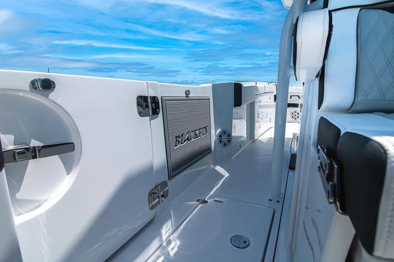 Slide: The Image of 2024 Blackfin 332 CC boat interior with sleek design and modern features under a clear blue sky. - 4