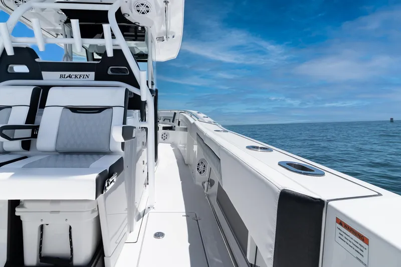 Slide: The Image of 2024 Blackfin 332 CC boat interior with sleek seating and ocean view. - 5