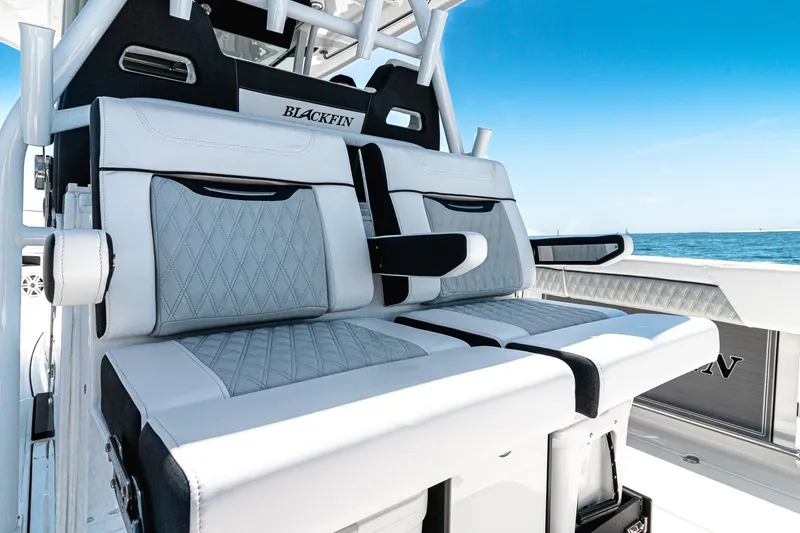 Slide: The Image of 2024 Blackfin 332 CC boat seats with luxurious white and gray upholstery, ocean backdrop. - 6