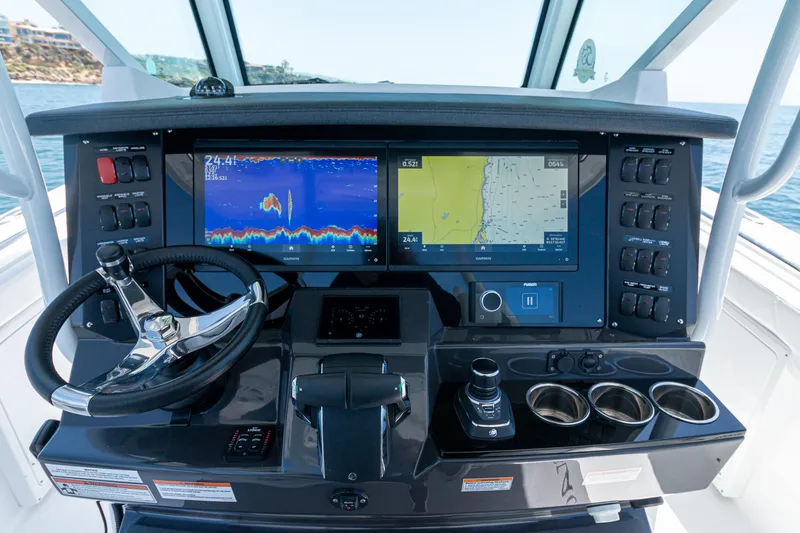 Slide: The Image of 2024 Blackfin 332 CC boat dashboard with navigation screens and controls. - 9
