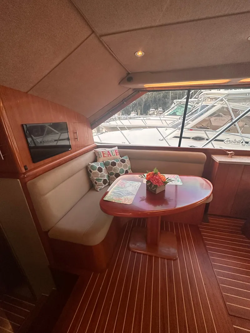 Slide: The Image of Interior of 1993 Ocean Yachts 42 Flybridge with cozy seating and table. - 15