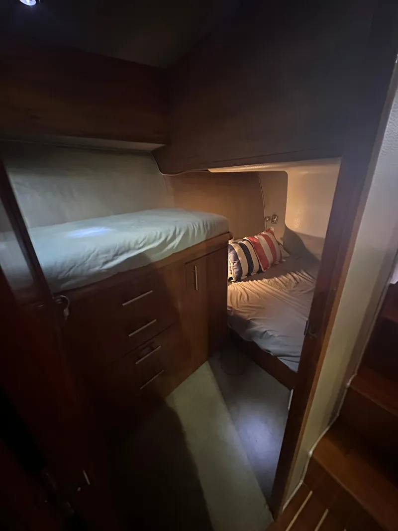 Slide: The Image of Cozy cabin interior of 1993 Ocean Yachts 42 Flybridge with bunk beds and wooden cabinetry. - 17