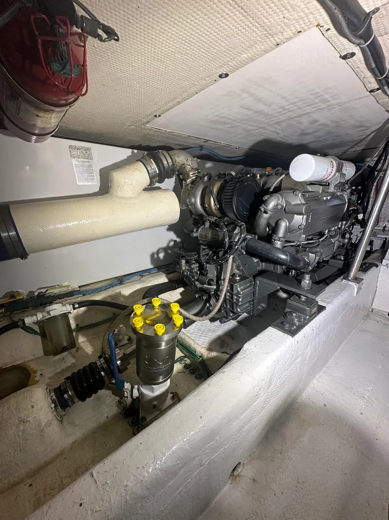 Slide: The Image of Engine room of 1993 Ocean Yachts 42 Flybridge, showcasing mechanical components and piping. - 20