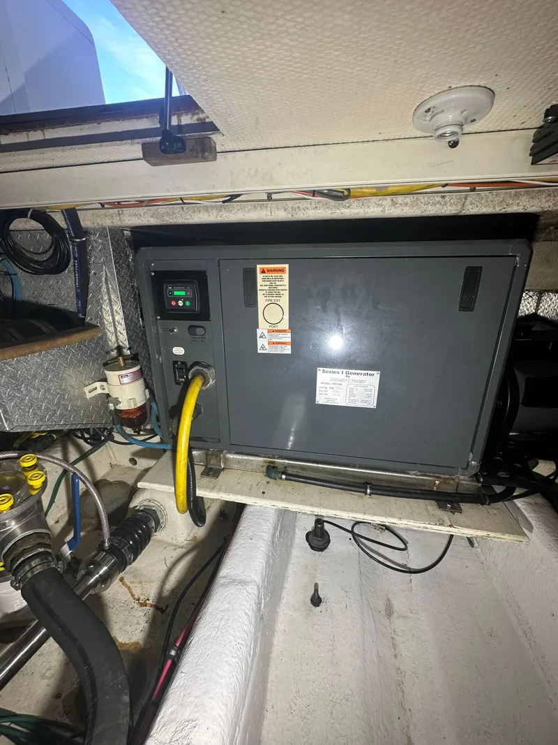 Slide: The Image of Engine room of 1993 Ocean Yachts 42 Flybridge with generator and wiring. - 22