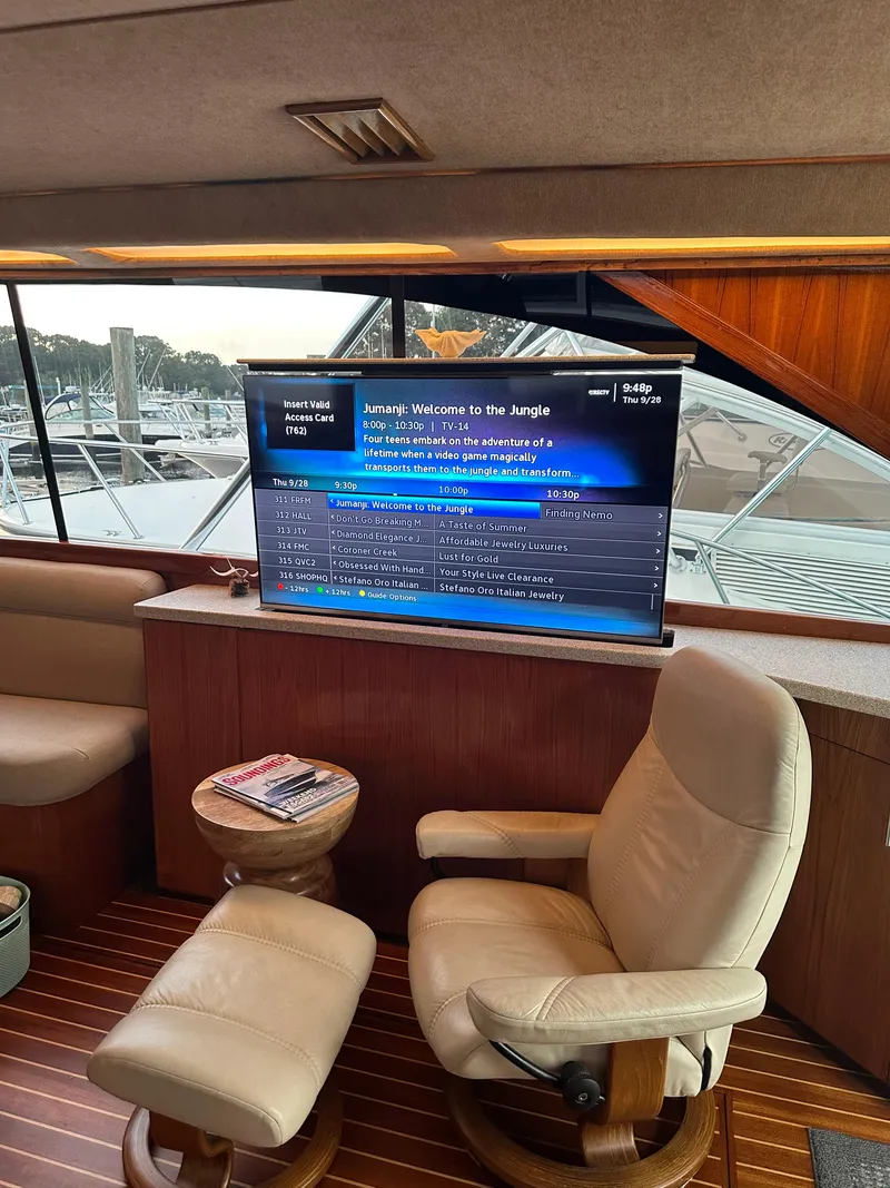 Slide: The Image of Luxurious 1993 Ocean Yachts 42 Flybridge interior with TV and comfortable seating. - 23