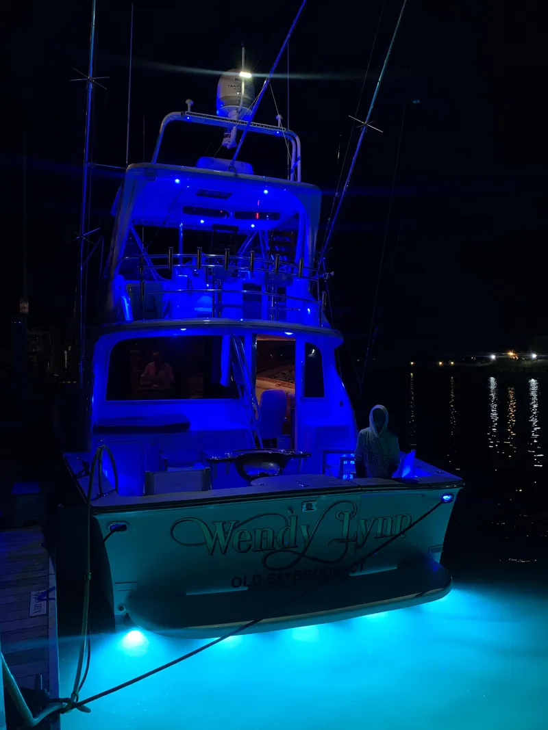 Slide: The Image of 1993 Ocean Yachts 42 Flybridge illuminated at night with blue lights. - 3
