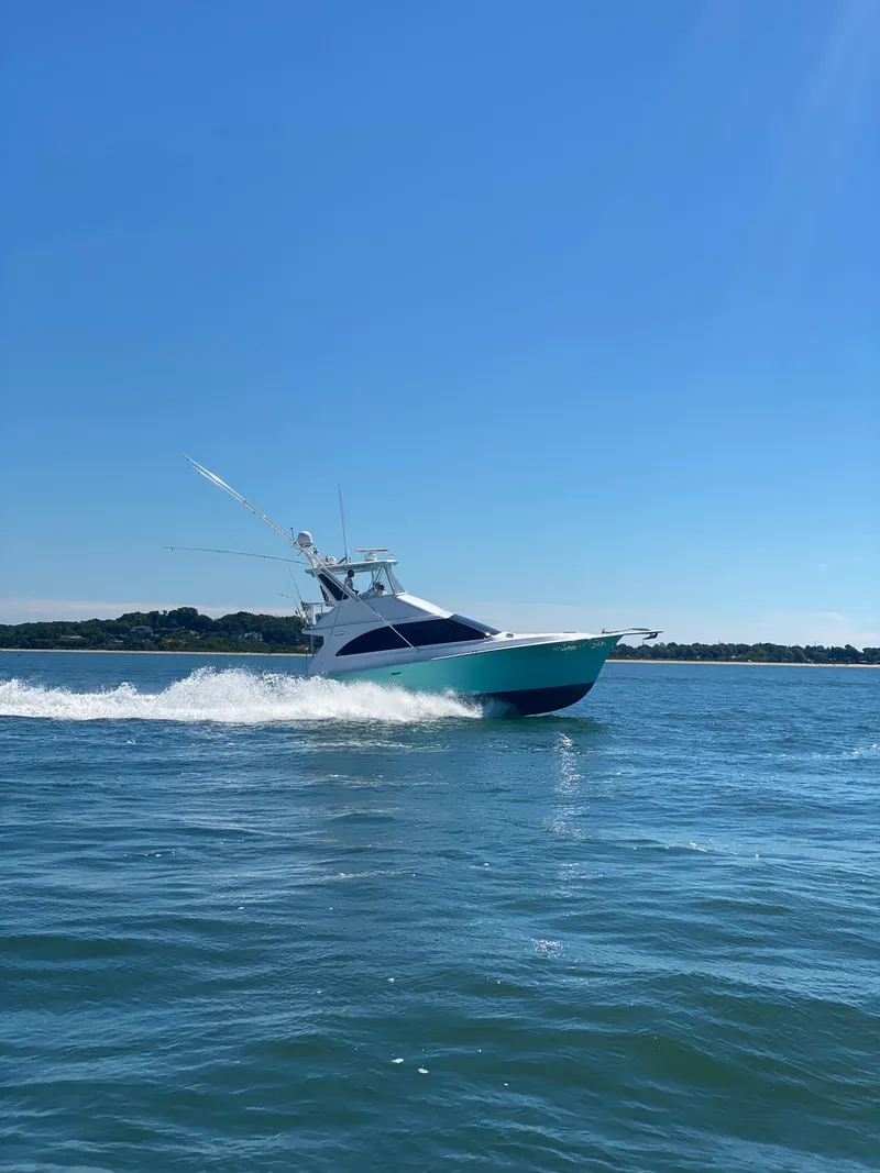 Slide: The Image of Ocean Yachts 42 Flybridge 1993 cruising on open water under clear blue sky. - 4