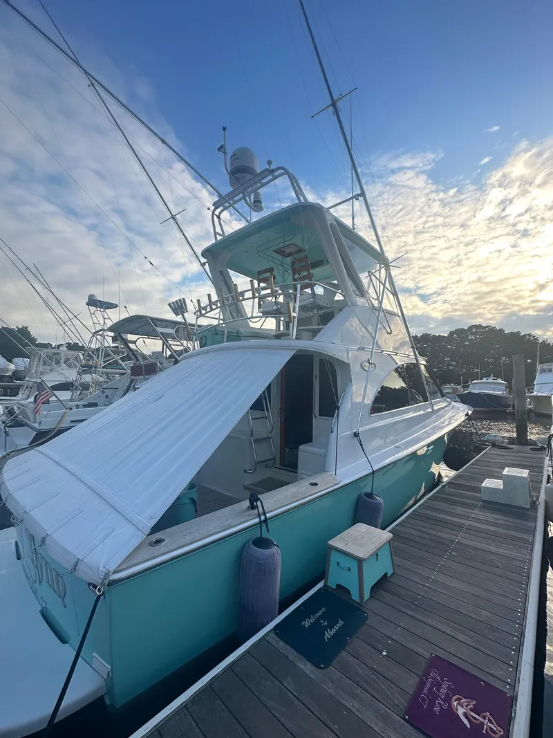 Slide: The Image of 1993 Ocean Yachts 42 Flybridge docked at marina under a blue sky. - 5