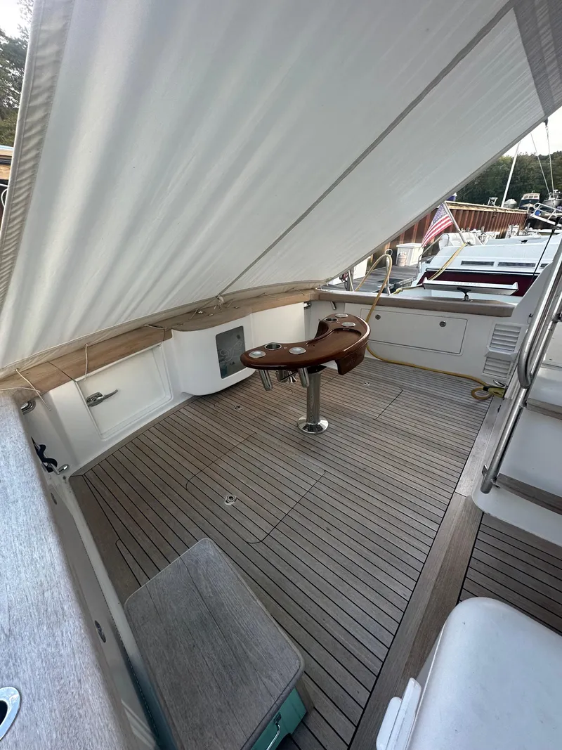 Slide: The Image of 1993 Ocean Yachts 42 Flybridge deck with wooden flooring and fishing chair. - 6