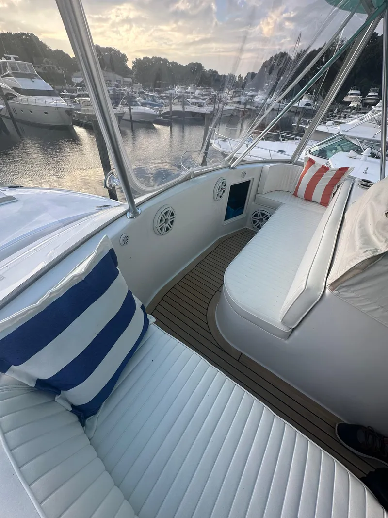 Slide: The Image of Luxurious seating area on a 1993 Ocean Yachts 42 Flybridge, docked at a marina. - 8