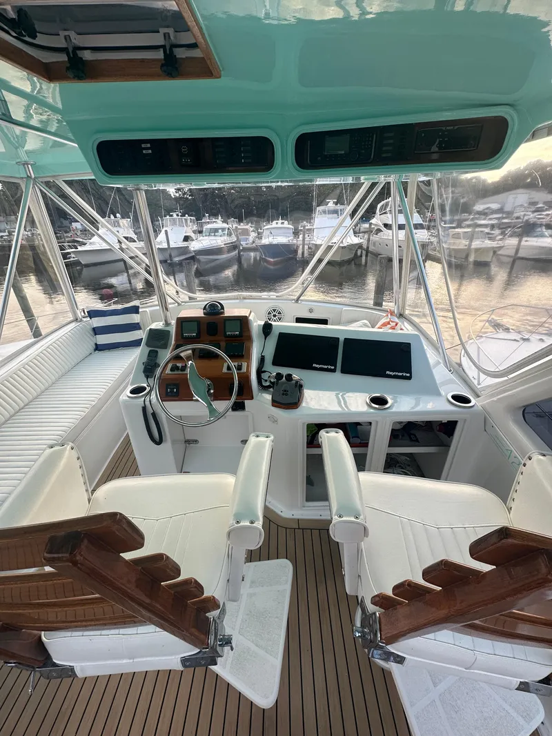 Slide: The Image of 1993 Ocean Yachts 42 Flybridge helm with dual seats, steering wheel, and navigation equipment. - 9