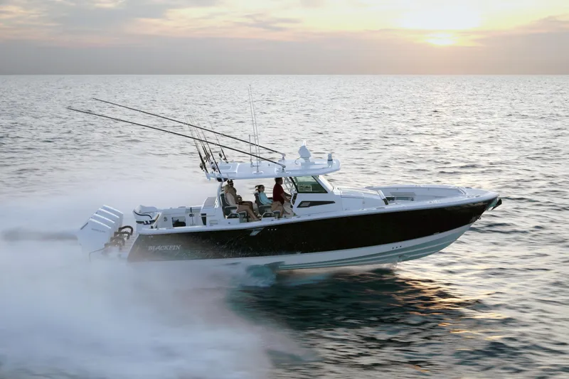 Slide: The Image of 2025 Blackfin 400 CC boat cruising at sunset on open water. - 1