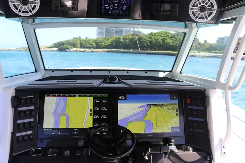 Slide: The Image of 2025 Blackfin 400 CC boat cockpit with advanced navigation screens and ocean view. - 18