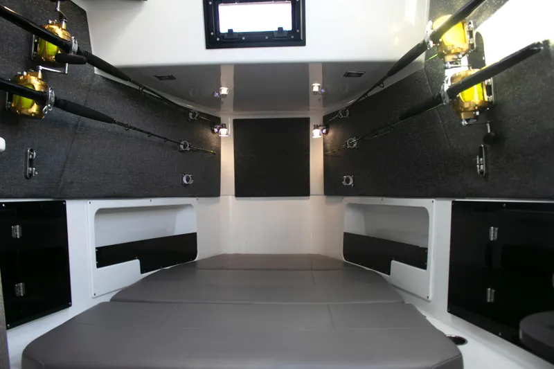 Slide: The Image of Interior of 2025 Blackfin 400 CC boat with fishing rods and cushioned seating. - 20