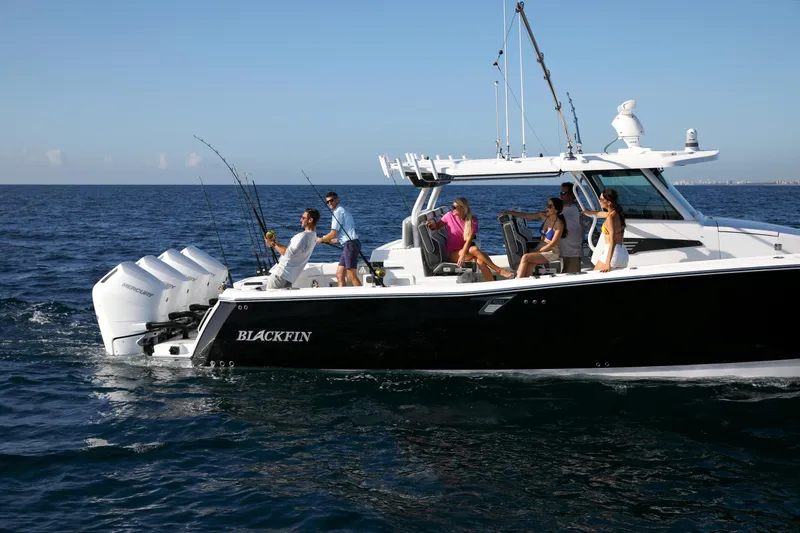 Slide: The Image of 2025 Blackfin 400 CC boat with people fishing on open water. - 3